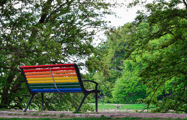 Rainbow colored bench in a park to celebrate diversity