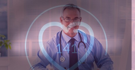 Heart icon with heart rate against portrait of caucasian senior male doctor smiling at hospital
