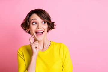 Photo of young happy positive excited pretty girl thinking look copyspace hold finger on chin isolated on pink color background