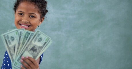 Composition of smiling girl holding american dollar bills on green background
