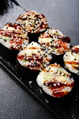 Japanese roll with salmon teriyaki sauce and soy sauce