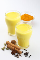 turmeric milk a healthy drink with herbs like ginger, cinnamon, holy basil or tulsi, star anise, clove, black pepper, turmeric powder. 