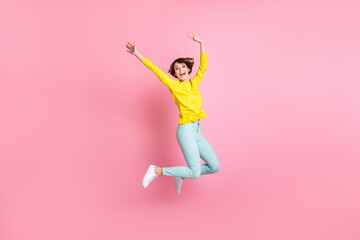 Fototapeta na wymiar Full size photo of young lovely happy excited cheerful smiling girl jumping in victory success isolated on pink color background