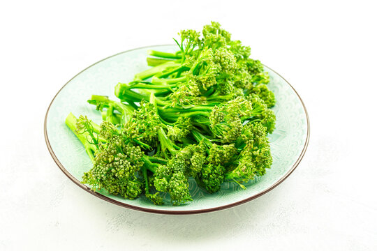 Organic Broccolini (bimi) in bowl on white background