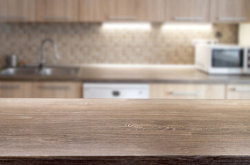 blurred kitchen interior and wooden desk space home background