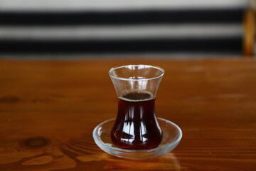 Thin belly, tea cup traditional serving style in Turkey for hot black tea.
Black tea serving style. Tea and coffee shop in Istanbul.
