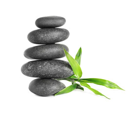 Stack of spa stones and bamboo sprout on white background