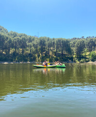 Fototapeta na wymiar Friends practicing kayaking on a sunny day in Madrid, Spain.