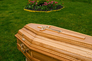 Burial coffins on a background of green grass.