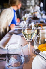 Glassware, glasses for white wine on a table in the restaurant. Banquet, cutlery, table setting. 