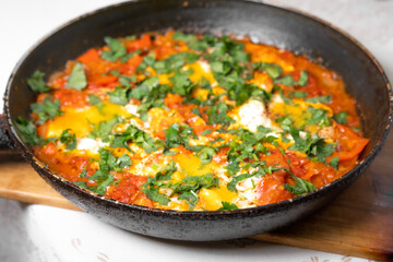 Scrambled eggs cooked in a metal frying pan