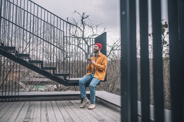 Man sitting on the steps of the city bridge