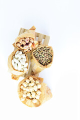 Zenithal view, healthy food bags, assortment of dried legumes on pallet.
Copy space. Minimalist and idea. White background.