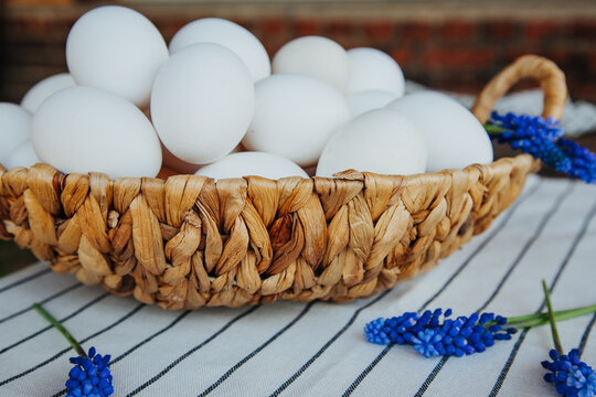 white eggs on striped tablecloths and blue muskari flowers