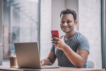 Young businessman sitting at the table in the office