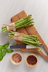 banches of fresh green asparagus on wooden background, fresh asparagus on wooden. group of Fresh asparagus on the wood background, raw vegetable food for health cook. and spices. Healthy food.