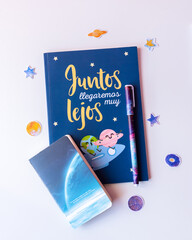 Creative writing notebook, astronomy, space, galaxies and stars, inspirational and creative phrase, pen