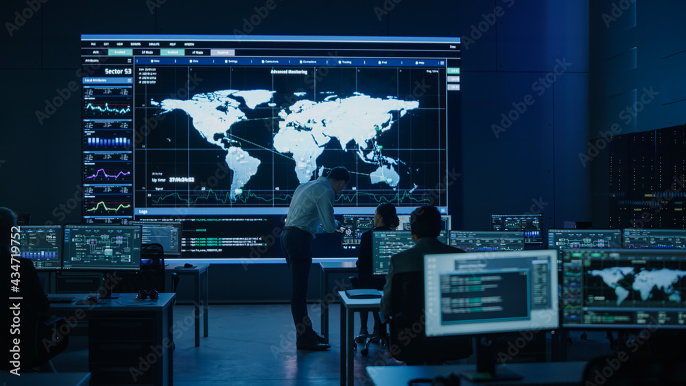 Aufkleber Project Manager Uses Digital Tablet Talks with Colleague. Big Screen Display Showing Infographics and Global World Map Data. Telecommunications Control Monitoring Room with People Working