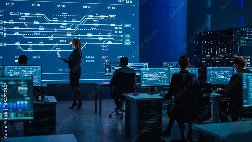 Fototapete Telecommunications Company System Control and Monitoring Room with Diverse Multicultural Team of Professionals Working on Computers. Big Screen Display Showing Infrastructure Infographics and Data