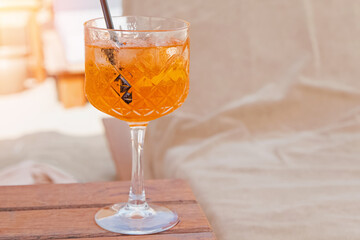Close-up of crystal glass with orange drink.
