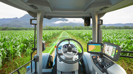 5G autonomous tractor working in corn field, Future technology with smart agriculture farming concept