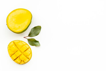 Mango fruit and mango cubes top view. Tropical fruits background