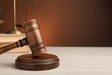 Wooden gavel on white table, space for text. Law concept
