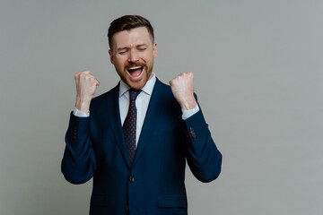 Excited professional businessman screaming and celebrating triumph