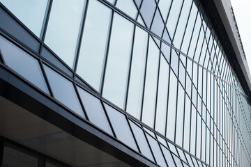 Modern glass building with geometric shapes. Interior of a business office or shopping center, perspective view. Facade of architecture.