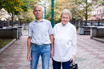mature couple of man with a woman strolling outdoor in park