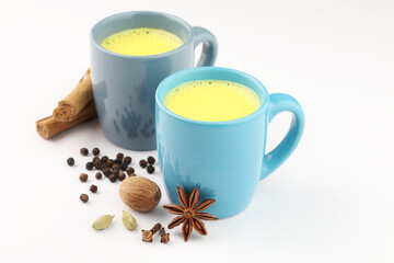 turmeric milk or haldi milk, Indian traditional home remedy. turmeric milk with star anise, black pepper, cinnamon, cardamom, nutmeg, clove,