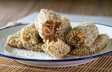 Duck Neck Snacks in white dish, and Chinese tea,  Dessert of Chinese put on bamboo mat and brown wooden table