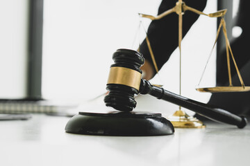 Obraz premium Judge gavel with Justice lawyers, Business woam in suit or lawyer working on a documents. Legal law, advice and justice concept.