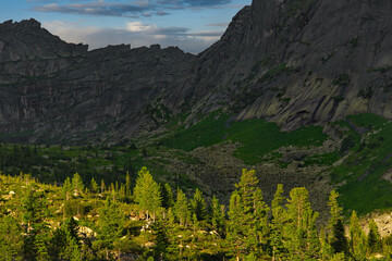 Russia. South of the Krasnoyarsk Territory. Amazing contrasts of light and shadow on a sunny summer evening in the natural mountain park of Ergaki.
