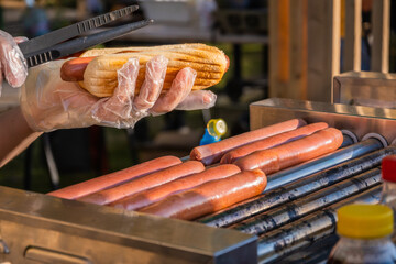 Sausages are fried on a rotary cooking machine