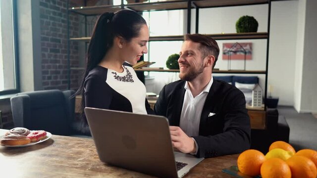 happy couple looking on screen laptop talking happy smiling at home flat interior