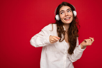 Attractive happy smiling young brunette female person wearing white shirt and optical glasses...