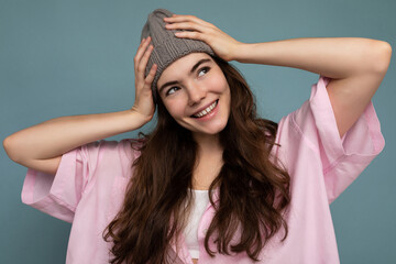 Beautiful positive happy young dark brunette woman isolated over colourful background wall wearing casual stylish clothes feeling sincere emotions looking to the side