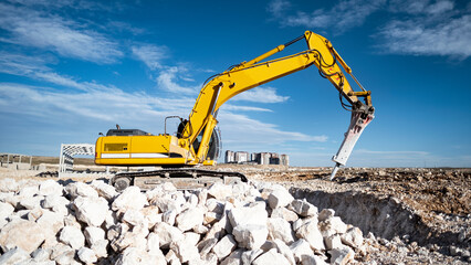a heavy industrial machine, demolishes an old abandoned area © Bircan
