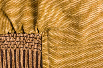 clothing items stonewashed cotton fabric texture with seams, clasps, buttons and rivets, macro