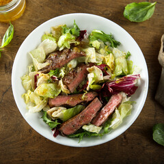 Healthy green salad with grilled beef steak