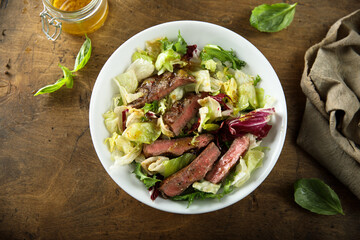 Healthy green salad with grilled beef steak