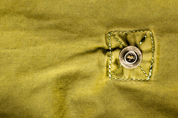 clothing items stonewashed cotton fabric texture with seams, clasps, buttons and rivets, macro