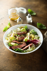 Healthy green salad with grilled beef steak