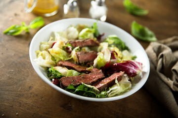 Healthy green salad with grilled beef steak