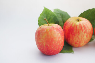 Close up of fresh apple with leaf on white background 