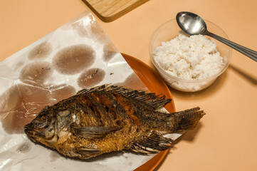 Top view of Homemade Thai style  deep fried Nile tilapia fish with Jasmin rice 