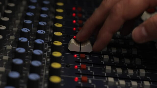 Audio mixer fader operating. Balancing volume of audio inputs of analog audio mixer.