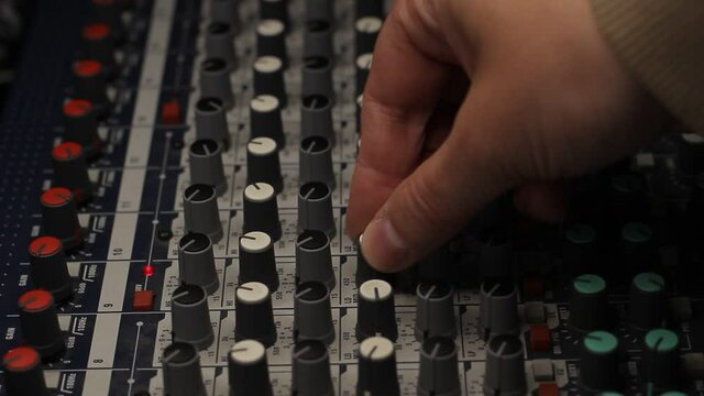 Audio mixer fader operating. Balancing volume of audio inputs of analog audio mixer.