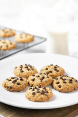 Delicious Whole Wheat Chocolate Chip Cookies set on white cafe table.